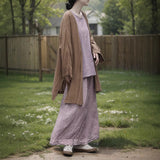 Shan Qian Nianyi, the spring new product has a simple design sense of A-shaped skirt, women's cotton and linen are quite wide, and the middle and long skirt with split ends.